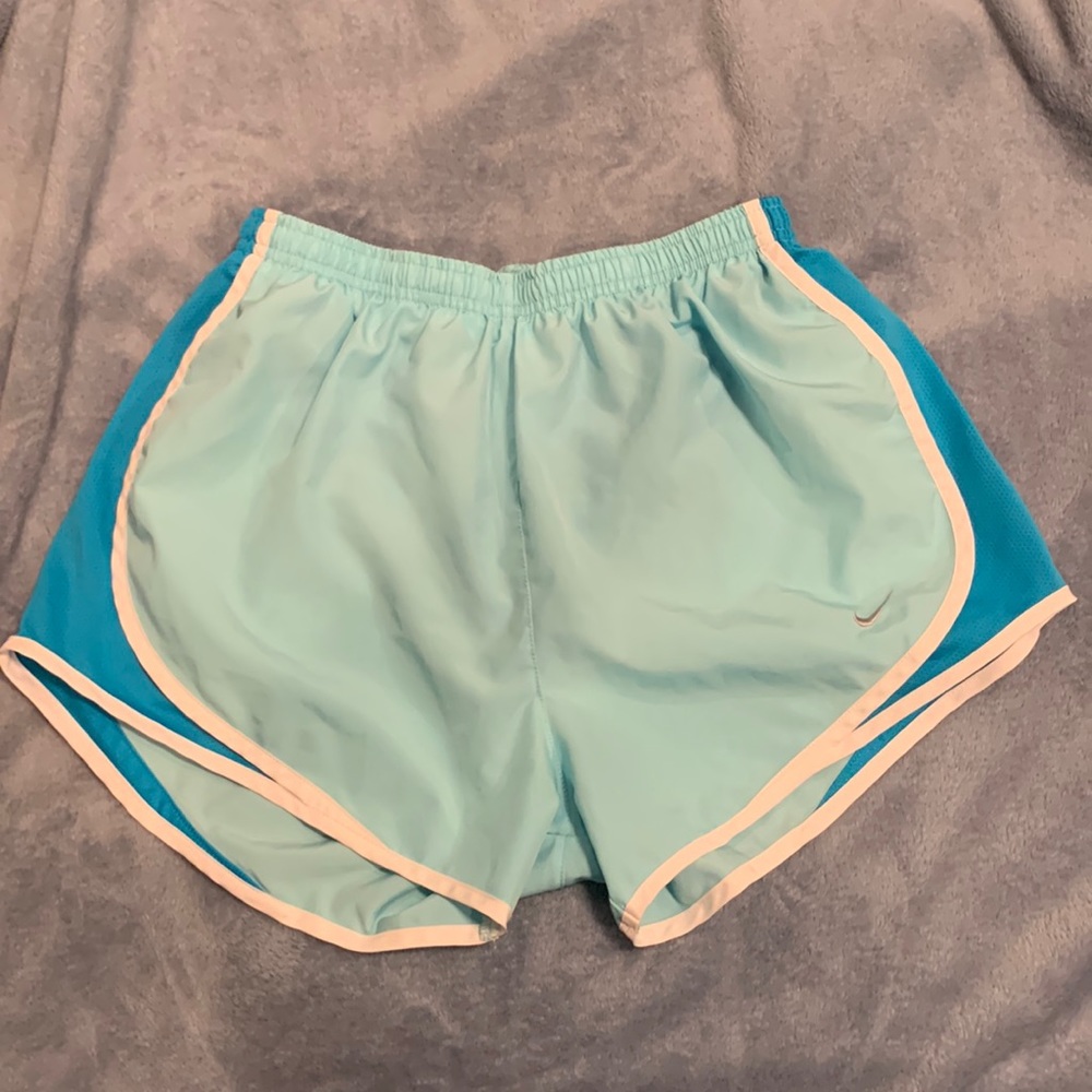 Blue Nike running shorts.